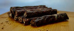 a chocolate cake sitting on top of a wooden cutting board 